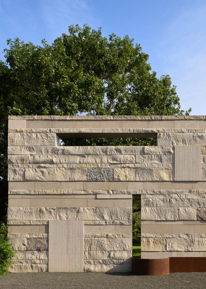 A stone-like wall with rectangular perforations at Casa Escuda by Tobin Smith Architect