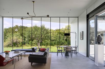 Open -plan living and dining room with floor-to-ceiling windows
