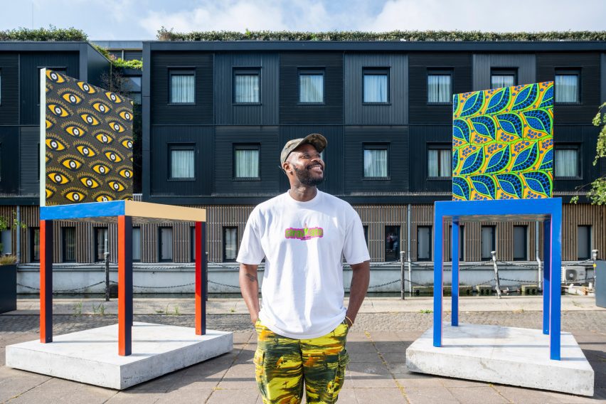 Designer Yinka Ilori in front of oversized chairs