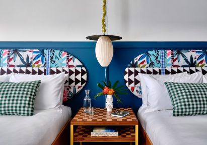 Pair of double beds with boldly patterned headboards