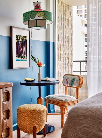 Seating area with small table in a blue hotel room
