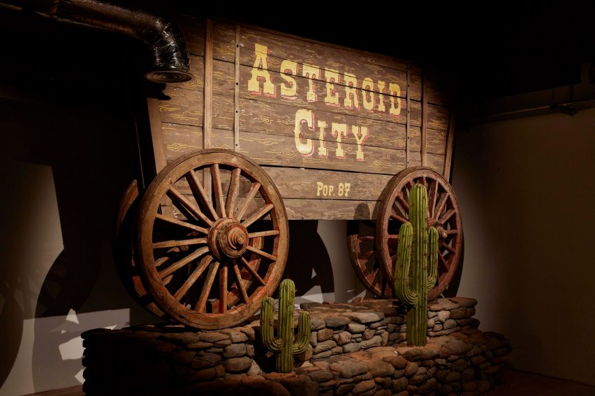 Asteroid City sign on a wooden cowboy-style wagon
