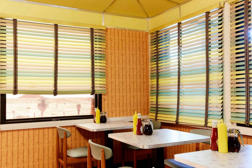 A 1950s-style diner with wooden seating and pastel blinds