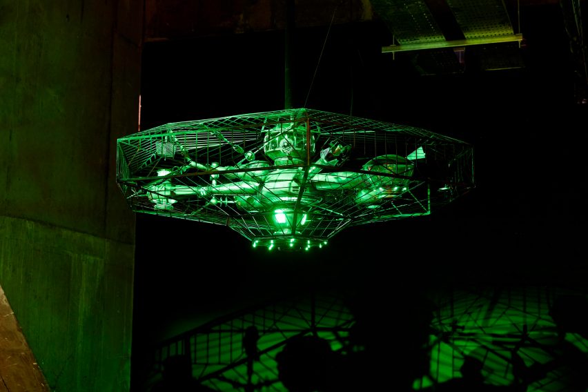 A UFO model lit up in green lights