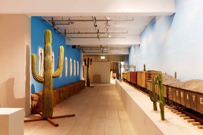 Asteroid City exhibition with a model train and cactus