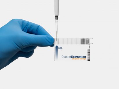 Gloved hand using pipette to fill segments of a medicine holder