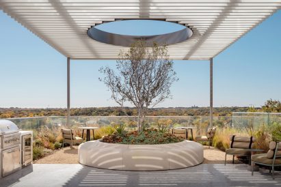 Covered patio with a tree growing through a hole in the canopy