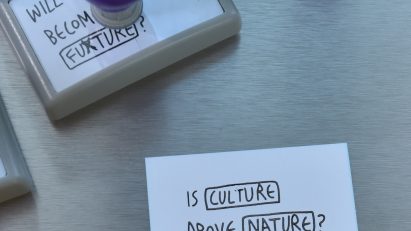 A photograph of a piece of paper that says "Is Culture Above Nature?"