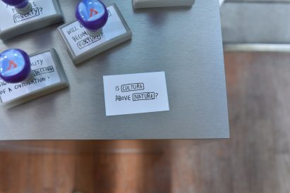 A photograph of a piece of paper that says "Is Culture Above Nature?"