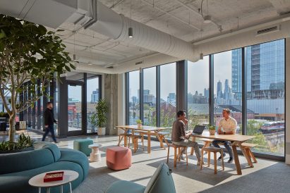 Allsteel's showroom workspace featuring people working at a table