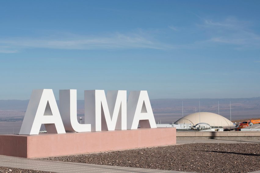 A large sign that says ALMA in front of a dome