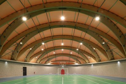 The interior of a sports complex with wood beams