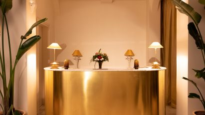 Curved brass hotel reception desk