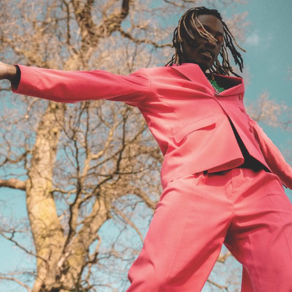 Man dancing in a pink suit