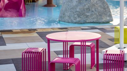 Hot pink dining set by pool with slides