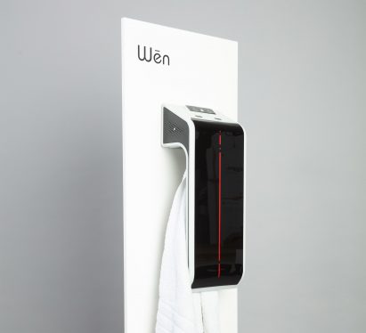 Body heater fixed on a white board with a towel hung inside