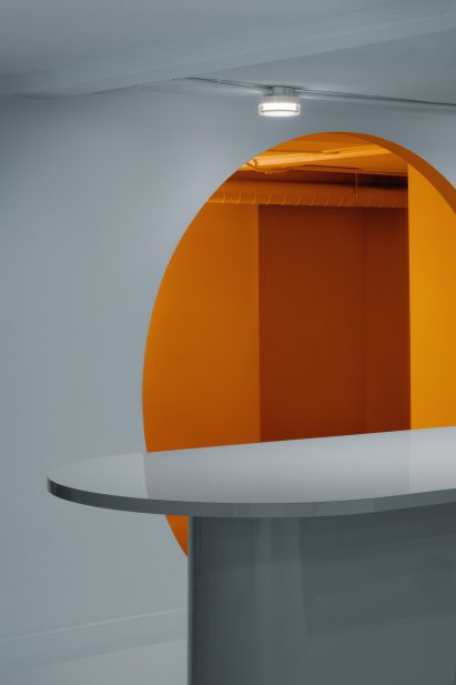 Blue kitchen with orange room beyond