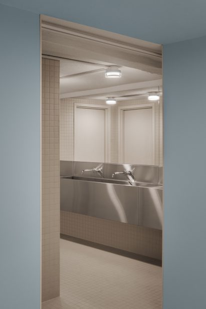 Bathroom with grey tiles viewed from blue room