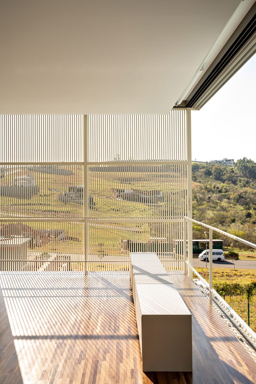 A room in Brazil with one open wall and another made with a metal screen