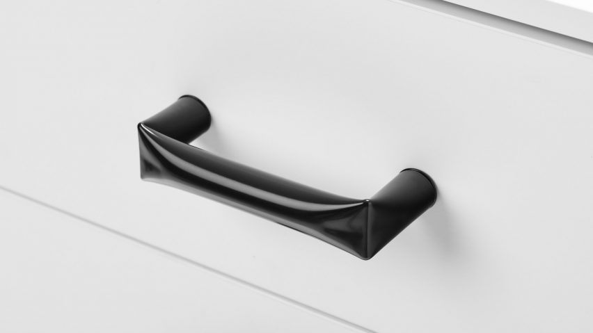 Black metal handle on white draw