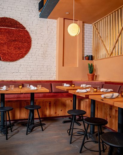 Reclaimed Douglas fir tables and stained plywood banquettes