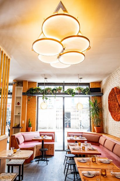 Circular light fixture above the dining area in Donna restaurant