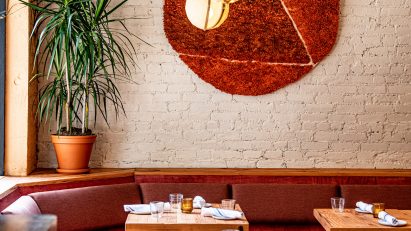 Donna bar interior with banquettes and wool wall hanging
