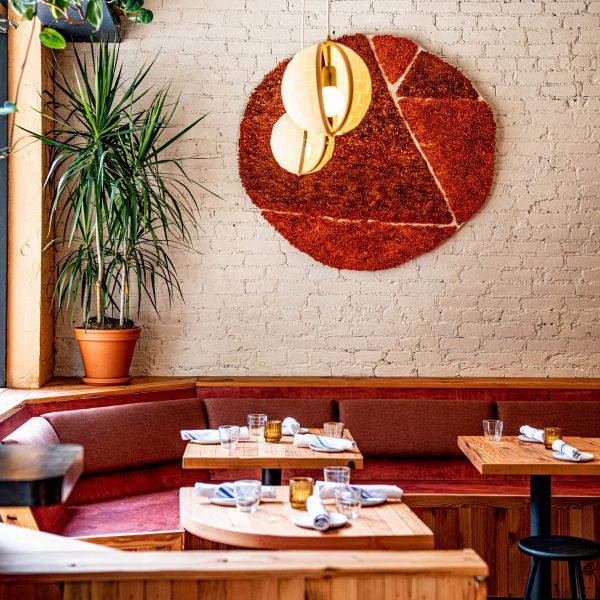 Donna bar interior with banquettes and wool wall hanging