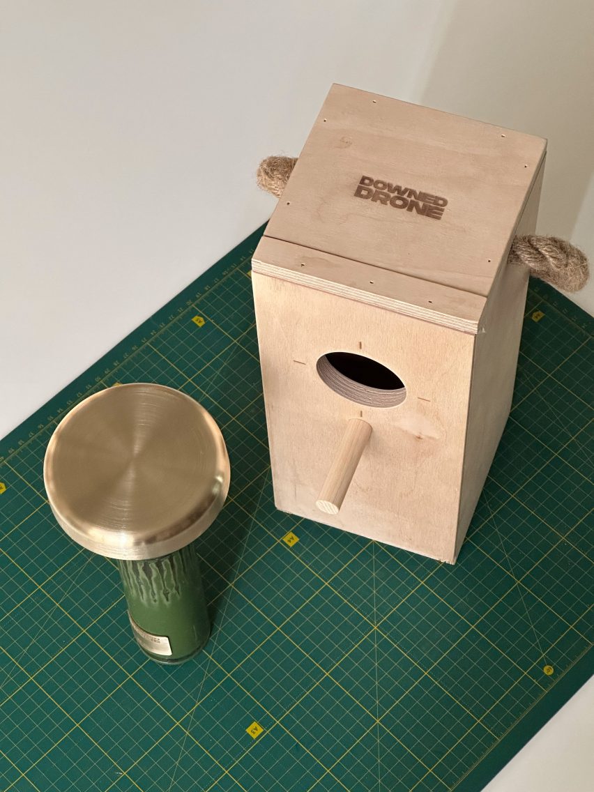 Dark green lamp beside wooden bird box