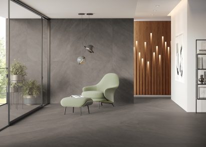 Mint-green chair and foot stool in grey-tiled living room