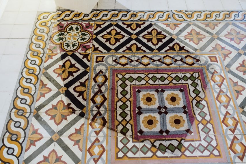 A rug mimicking surrounding patterned tiles