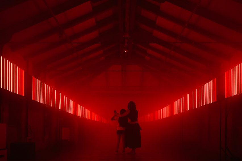 Red light installation in a pitched-roof interior