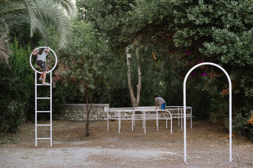 White metal play sculptures in a garden