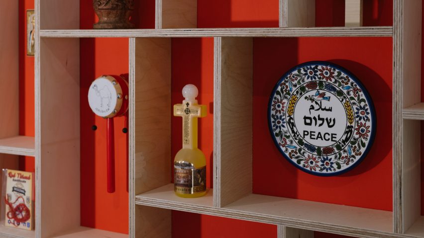 Gridded wooden shelving with traditional Israeli objects displayed