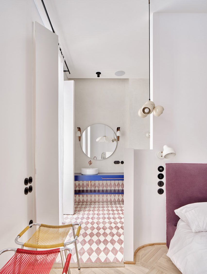 Bedroom and en-suite with patterned floor tiles in JJ16 apartment by Lucas y Hernández-Gil