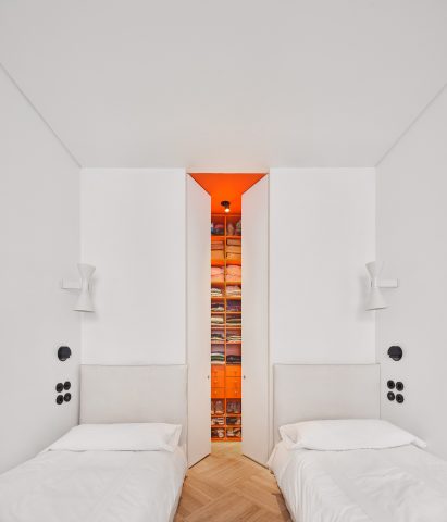 Bedroom with orange walk-in closet in JJ16 apartment by Lucas y Hernández-Gil
