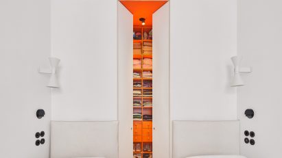 Bedroom with orange walk-in closet in JJ16 apartment by Lucas y Hernández-Gil