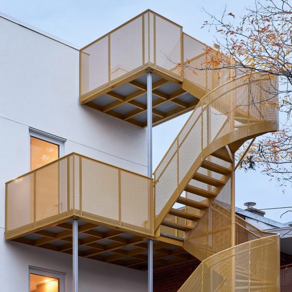 Yellow exterior staircase on apartment block