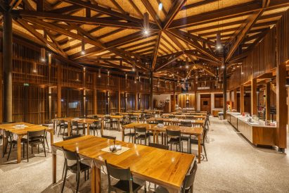 Wood-clad dining space within monastery by Mixtura