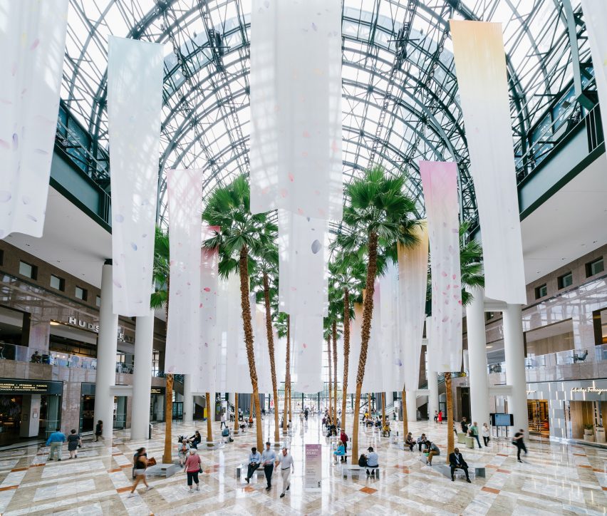 suspended banners in a lobby underneath a glass atrium
