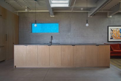 Rectilinear hole revealing a swimming pool in the kitchen
