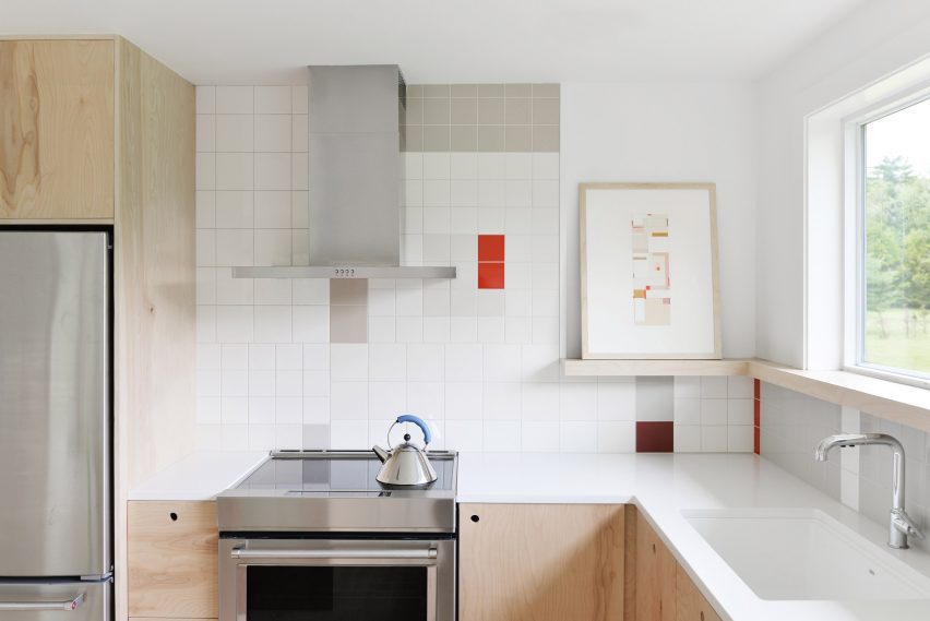 Kitchen with geometric colourful wall tiles and wood kitchen units