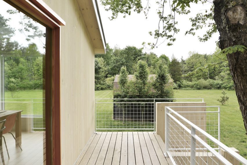 Elevated wood decking outside a ranch house in New York