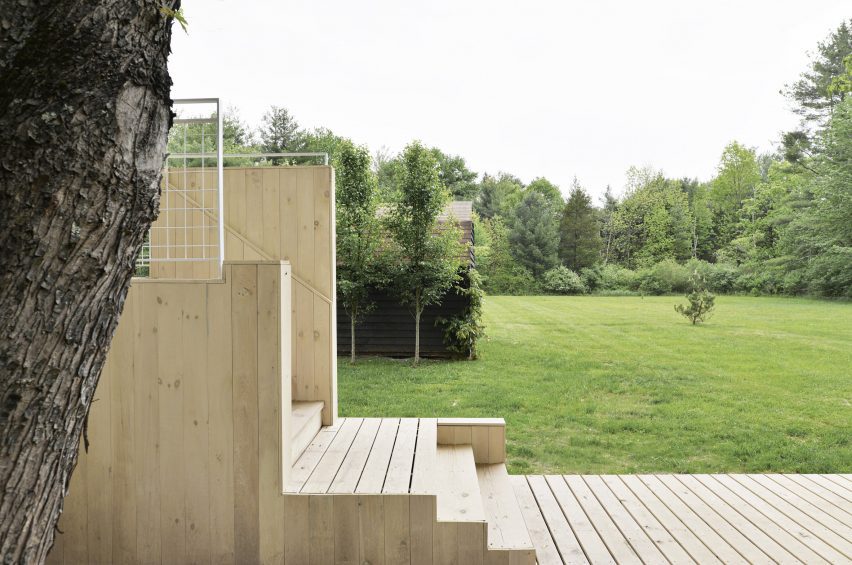 Stepped wood decking outside a ranch house in New York