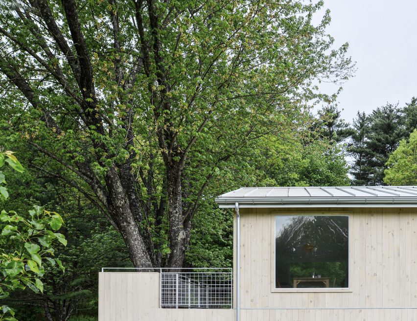 Wood-clad ranch house in a wooded area