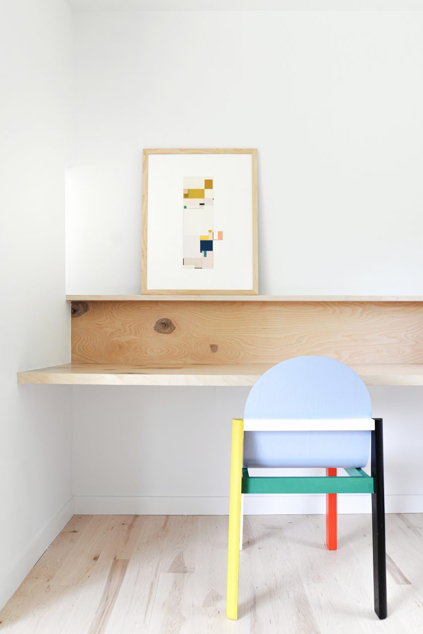 Office nook with a custom-built wood desk and colourful chair