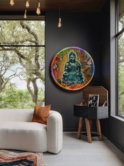 Neon Buddha piece in the primary bedroom