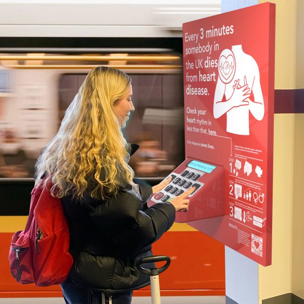 Person stood at an interactive poster for heart health