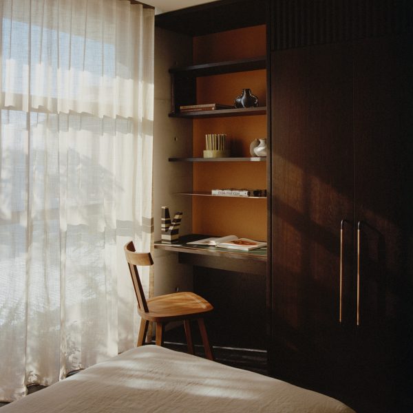 Dark wood desk next to built-in wardrobes in Fisherman's Cottage