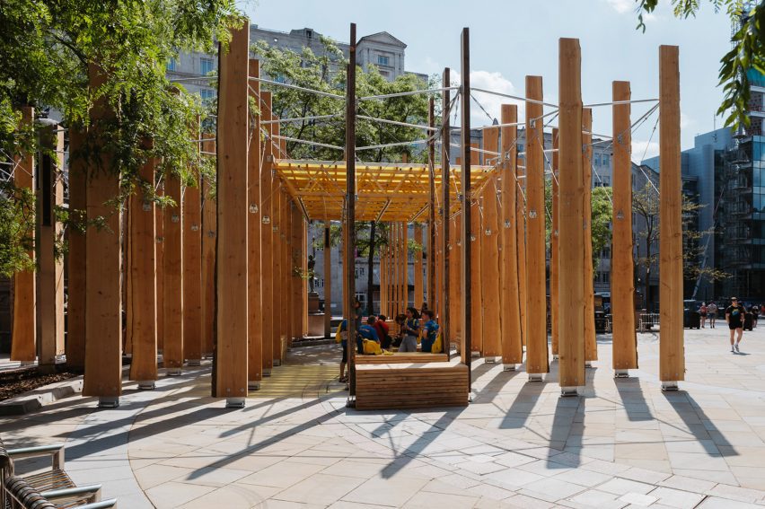 Wooden seats for pedestrians amidst timber installation